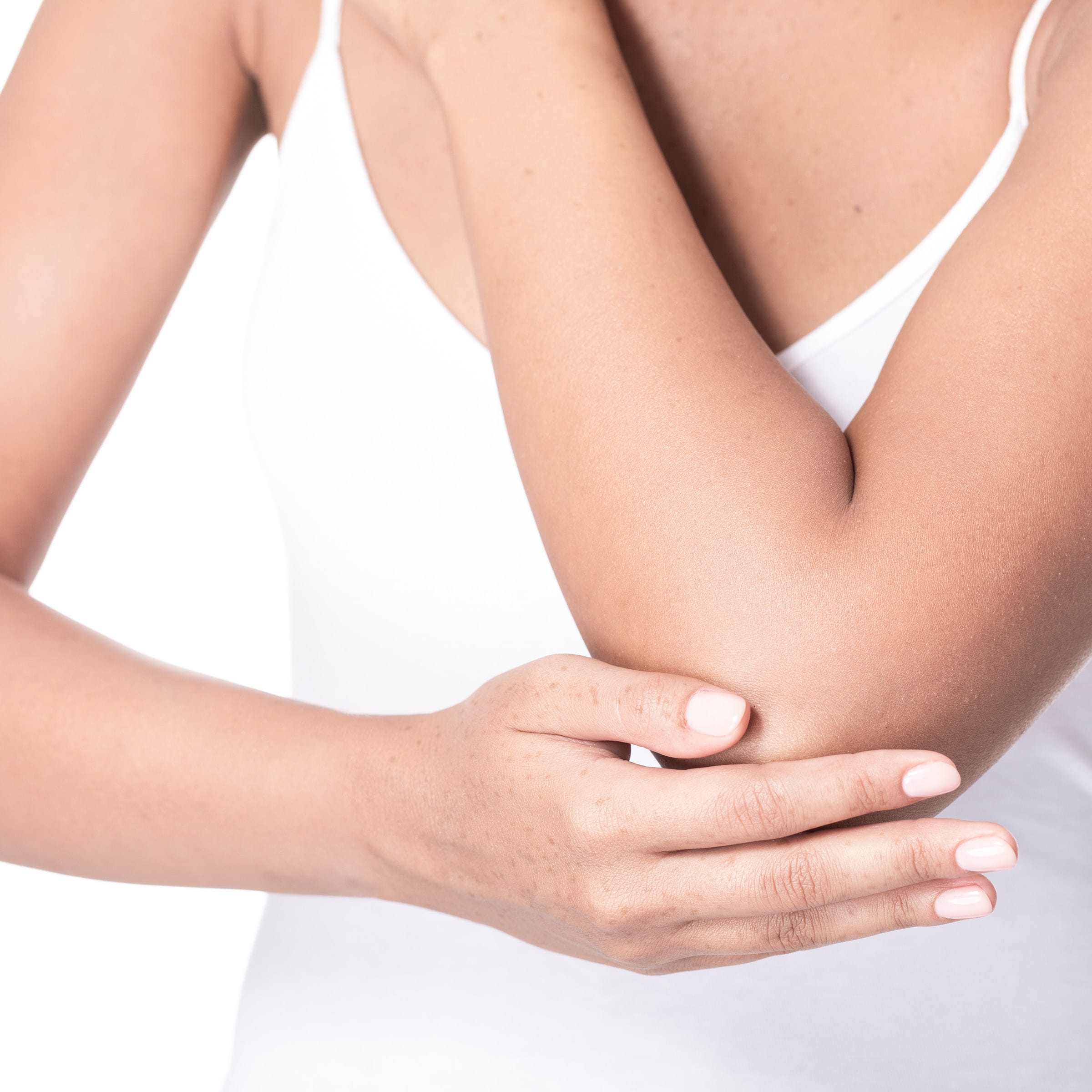 Woman, stroking her extremely dry elbow